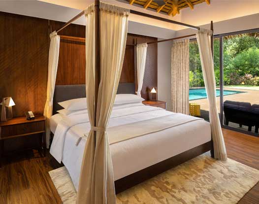 Spacious master bedroom with pool access at Bougainville Resorts