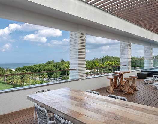 Private deck with ocean view seating at Bougainville Resorts